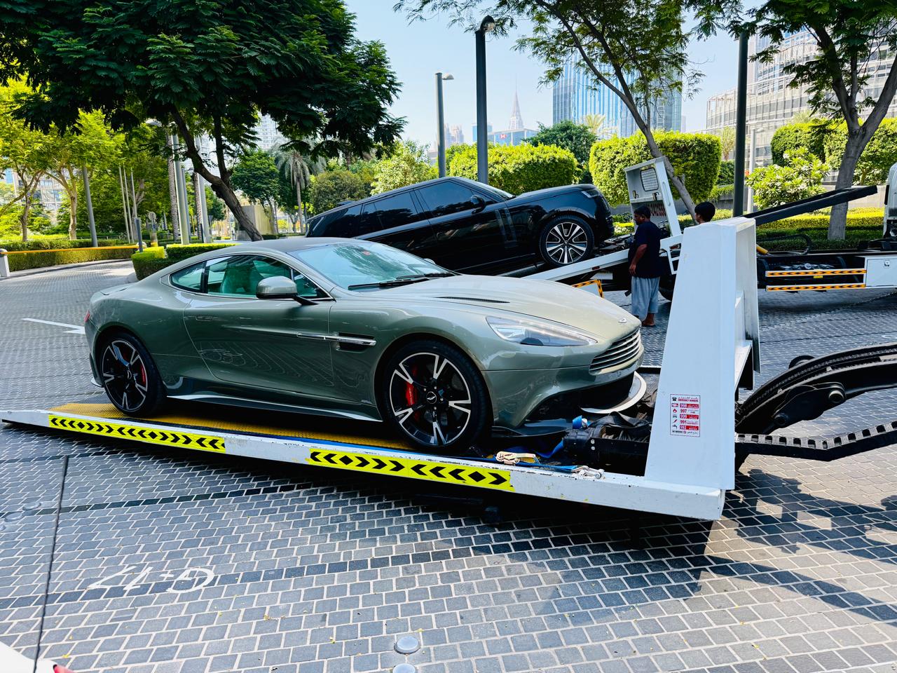 Aston Martin sports car loaded on a flatbed recovery truck in Dubai