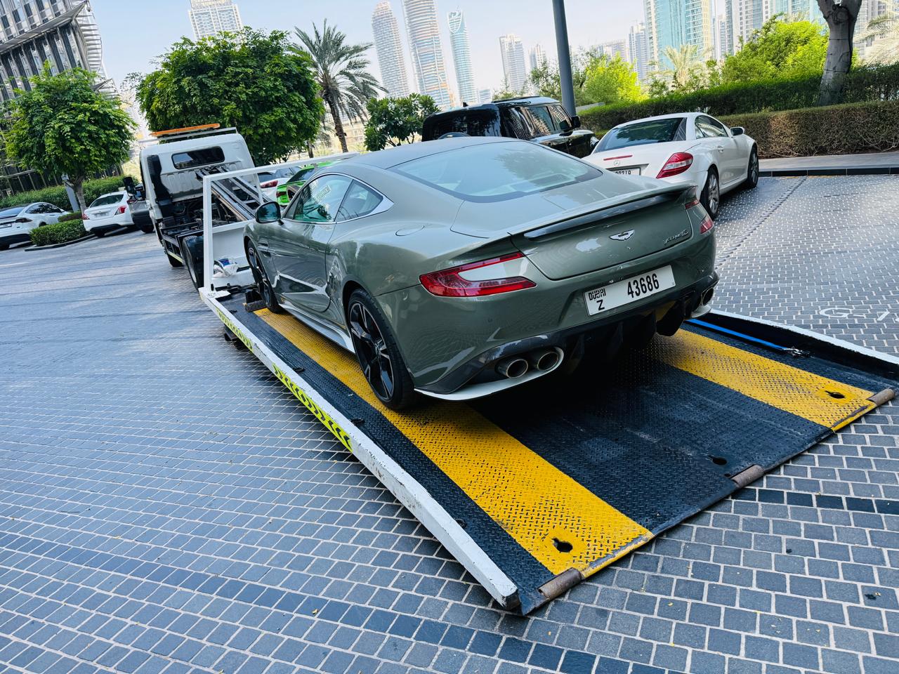 Aston Martin recovery near Dubai Marina on a flatbed recovery truck