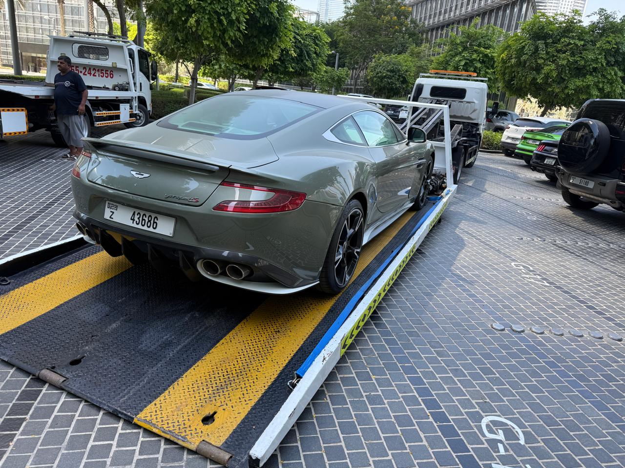 Aston Martin Vanquish sports car recovery on a flatbed in Dubai