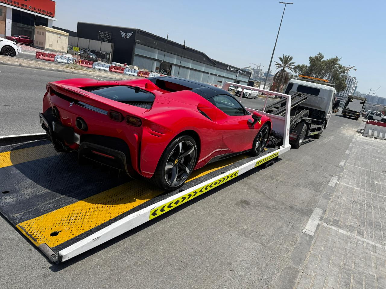 Ferrari SF90 full down recovery loaded level on a flatbed in Dubai