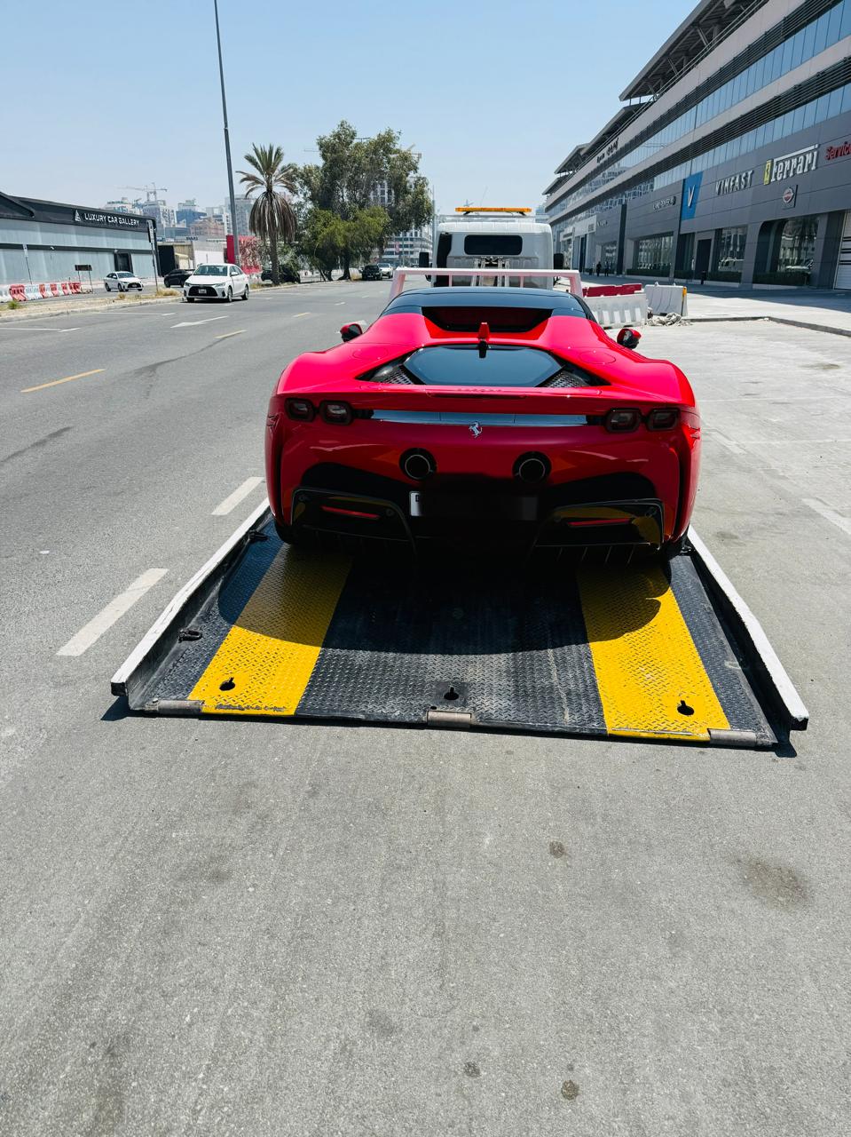 Ferrari SF90 recovery near me on a flatbed truck in Dubai
